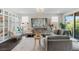 Cozy living room featuring custom built-ins, comfortable seating, and natural light from sliding glass doors at 64 Lake Oasis St, Henderson, NV 89011
