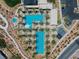 A bird's eye view of two pools surrounded by palm trees and lounge chairs at 64 Lake Oasis St, Henderson, NV 89011