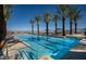 Stunning swimming pool with palm trees and clear blue water provides a luxurious outdoor amenity at 64 Lake Oasis St, Henderson, NV 89011