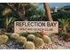 Attractive entrance sign for Reflection Bay Golf and Beach Club surrounded by beautiful desert landscaping at 64 Lake Oasis St, Henderson, NV 89011