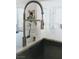 Close up of a stainless sink with chrome faucet and granite countertop at 64 Lake Oasis St, Henderson, NV 89011