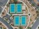 Overhead shot showcases pristine tennis courts with manicured landscaping in a picturesque neighborhood at 64 Lake Oasis St, Henderson, NV 89011
