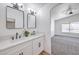 Elegant bathroom vanity with double sinks, modern fixtures, and large mirrors at 6456 First View Ave, Las Vegas, NV 89142