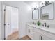 Bathroom with double vanity, mirrors, and modern fixtures near tub at 6456 First View Ave, Las Vegas, NV 89142