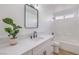 Clean bathroom featuring a white vanity, mirror, and shower-tub combo at 6456 First View Ave, Las Vegas, NV 89142
