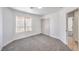 This bedroom features neutral carpet, white walls, a window, and a closet at 6456 First View Ave, Las Vegas, NV 89142