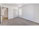 This bedroom has neutral carpet, white walls, a window, and a closet at 6456 First View Ave, Las Vegas, NV 89142