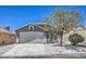 Charming home exterior featuring a well-maintained lawn and a spacious two-car garage at 6456 First View Ave, Las Vegas, NV 89142