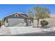 Inviting home with a two-car garage, mature tree, and low-maintenance gravel landscaping at 6456 First View Ave, Las Vegas, NV 89142