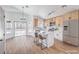 An open kitchen featuring an island with barstools, stainless steel appliances, and sliding glass doors to the yard at 6456 First View Ave, Las Vegas, NV 89142