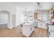 Bright open concept kitchen features stainless steel appliances, island seating, and modern lighting fixtures at 6456 First View Ave, Las Vegas, NV 89142
