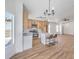 Bright open concept kitchen features stainless steel appliances, island seating, and modern lighting fixtures at 6456 First View Ave, Las Vegas, NV 89142