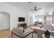 A bright and airy living room with contemporary furnishings, a ceiling fan, and wood-look flooring at 6456 First View Ave, Las Vegas, NV 89142