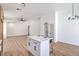 Bright open concept living room featuring light colored flooring with direct access to kitchen at 6456 First View Ave, Las Vegas, NV 89142