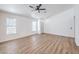 Bright living area with hardwood floors, ceiling fan, and fresh, neutral paint throughout the home at 6456 First View Ave, Las Vegas, NV 89142