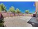 Private backyard featuring gravel landscaping, a concrete patio, and brick perimeter walls at 6564 Baroque Ave, Las Vegas, NV 89139