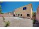 Landscaped backyard featuring a large patio space, rock landscaping, and block wall at 6564 Baroque Ave, Las Vegas, NV 89139