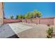 Private backyard with brick wall and a mix of concrete and gravel landscaping at 6564 Baroque Ave, Las Vegas, NV 89139