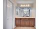 Bathroom featuring a marble vanity with double sinks and large mirrors at 6564 Baroque Ave, Las Vegas, NV 89139
