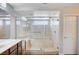 Bathroom featuring a large walk-in shower with tile surround and glass enclosure at 6564 Baroque Ave, Las Vegas, NV 89139