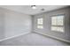 Bright bedroom with carpet, neutral walls, and two windows providing ample natural light at 6564 Baroque Ave, Las Vegas, NV 89139