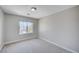 Bright, carpeted bedroom with a large window overlooking the neighborhood at 6564 Baroque Ave, Las Vegas, NV 89139