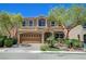 Charming two-story home featuring a well-manicured lawn, mature trees, and a two-car garage at 6564 Baroque Ave, Las Vegas, NV 89139