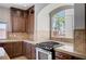 The kitchen features granite counters, stainless steel appliances, tile backsplash, and a large window at 6564 Baroque Ave, Las Vegas, NV 89139