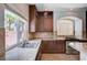 Kitchen featuring granite counters and dark wood cabinets with a garden view at 6564 Baroque Ave, Las Vegas, NV 89139