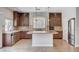 Spacious kitchen with a large island, dark wood cabinets, stainless steel appliances, and natural lighting at 6564 Baroque Ave, Las Vegas, NV 89139