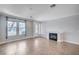 Bright living room featuring tile floors, a fireplace, large windows, and a light gray color palette at 6564 Baroque Ave, Las Vegas, NV 89139
