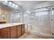 Luxury main bathroom with double vanities, a glass-enclosed shower, and a soaking tub at 6564 Baroque Ave, Las Vegas, NV 89139
