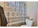 Bathroom showcasing a shower with a patterned curtain and toilet area at 6616 Celeste Ave, Las Vegas, NV 89107