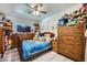 Bedroom showcasing a window for natural light, carpet flooring, and a ceiling fan at 6616 Celeste Ave, Las Vegas, NV 89107