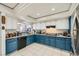 Open kitchen featuring blue cabinetry, white appliances, and tile floors at 6616 Celeste Ave, Las Vegas, NV 89107