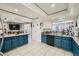 Open kitchen featuring blue cabinetry, white appliances, and tile floors at 6616 Celeste Ave, Las Vegas, NV 89107