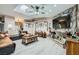 Bright living room featuring a stone fireplace, ceiling fan, and skylight at 6616 Celeste Ave, Las Vegas, NV 89107