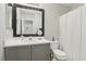 Bathroom with white vanity, toilet and shower featuring black framed mirror at 7640 Woven Memories St, Las Vegas, NV 89149