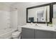 Well-maintained bathroom features a shower-tub combo, a modern vanity, and a large framed mirror at 7640 Woven Memories St, Las Vegas, NV 89149