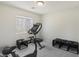 Carpeted bedroom with stationary bike and weight bench at 7640 Woven Memories St, Las Vegas, NV 89149