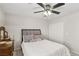 Comfortable bedroom features a ceiling fan, an upholstered headboard, a vanity, and a closet with sliding doors at 7640 Woven Memories St, Las Vegas, NV 89149