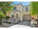 Charming two-story home featuring a covered front porch and a one-car garage at 7640 Woven Memories St, Las Vegas, NV 89149