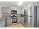 Kitchen with gray cabinets, stainless steel appliances, and tiled backsplash at 7640 Woven Memories St, Las Vegas, NV 89149