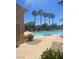 Cool off in the community pool with a tanning ledge, surrounded by beautiful palm trees at 7640 Woven Memories St, Las Vegas, NV 89149