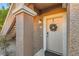 Inviting front entrance featuring a decorated door and well-maintained stucco exterior with a porch light at 830 Carnegie St # 512, Henderson, NV 89052
