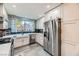 Well-equipped kitchen with stainless steel appliances, white cabinetry, and ample counter space for cooking at 830 Carnegie St # 512, Henderson, NV 89052