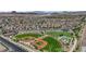 Aerial view of neighborhood featuring baseball fields, a playground, and many single-Gathering homes at 851 Klamath Springs St, Henderson, NV 89011