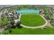 Aerial view of a neighborhood park featuring green space, a pond, trees, and walking paths at 851 Klamath Springs St, Henderson, NV 89011