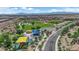 Aerial view of a neighborhood park featuring a playground, baseball fields, and open green space with mountain views at 851 Klamath Springs St, Henderson, NV 89011