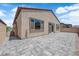 The backyard has pavers, block walls and a stucco exterior with a sliding glass door at 851 Klamath Springs St, Henderson, NV 89011